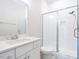 This bathroom has bright white tiles, vanity, glass shower, and modern sink, creating a clean and fresh space at 123 Cottage Way, Pittsboro, NC 27312