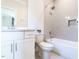 Bathroom features a shower over tub, white vanity, and tile surround at 123 Cottage Way, Pittsboro, NC 27312