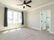 Bedroom with a ceiling fan, carpet, large windows, and a walk-in closet at 123 Cottage Way, Pittsboro, NC 27312