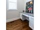 Desk nook features granite countertop, drawers, and a large floral print for a cozy workspace at 123 Cottage Way, Pittsboro, NC 27312