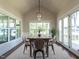 Bright dining room features vaulted ceilings, hardwood floors, and large windows with backyard views at 123 Cottage Way, Pittsboro, NC 27312