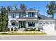 Beautiful two-story home with blue siding, black trim windows, manicured lawn, and an attached two-car garage at 123 Cottage Way, Pittsboro, NC 27312