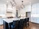 Spacious kitchen with a large island and seating, custom cabinets, stainless steel appliances, and hardwood floors at 123 Cottage Way, Pittsboro, NC 27312