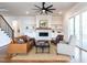 Bright living room featuring a ceiling fan, fireplace, and neutral colored furniture and decor at 123 Cottage Way, Pittsboro, NC 27312