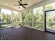 Screened porch with dark wood flooring and views of the wooded backyard at 123 Cottage Way, Pittsboro, NC 27312