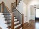 Beautiful staircase with wood treads, white risers, and black iron balusters leading to the upper level at 123 Cottage Way, Pittsboro, NC 27312