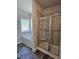 Bathroom featuring large tub and separate tiled shower with glass doors and window at 28 Decatur Dr, Fuquay Varina, NC 27526
