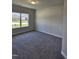 Bedroom with neutral walls, plush carpet, and a large window providing natural light at 28 Decatur Dr, Fuquay Varina, NC 27526