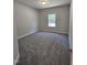 Carpeted bedroom with a window providing ample natural light at 28 Decatur Dr, Fuquay Varina, NC 27526