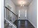 Home entryway with a staircase, chandelier lighting, and dark floors at 42 Decatur Dr, Fuquay Varina, NC 27526