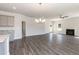 Spacious living room featuring a fireplace, ceiling fan, and gray hardwood flooring at 42 Decatur Dr, Fuquay Varina, NC 27526