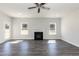 Spacious living room with dark flooring, a fireplace and backyard views at 42 Decatur Dr, Fuquay Varina, NC 27526
