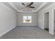 Bright main bedroom with a tray ceiling, fan, and a large window at 42 Decatur Dr, Fuquay Varina, NC 27526