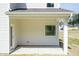 Covered patio featuring a door, window, and concrete flooring, perfect for outdoor relaxation at 42 Decatur Dr, Fuquay Varina, NC 27526
