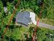 An aerial perspective reveals this beautiful home surrounded by vibrant greenery and a winding driveway at 5406 Garrett Rd, Durham, NC 27707