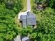 A captivating aerial shot showcases this property with lush surroundings and a winding driveway at 5406 Garrett Rd, Durham, NC 27707