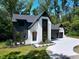 Modern two-story home with white brick, black trim, landscaped yard, and a concrete driveway at 5406 Garrett Rd, Durham, NC 27707