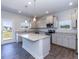 Modern kitchen with stainless steel appliances, a kitchen island, and light gray cabinets at 56 Decatur Dr, Fuquay Varina, NC 27526