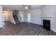 Spacious living room featuring hardwood floors, a fireplace, and staircase at 56 Decatur Dr, Fuquay Varina, NC 27526