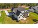 Aerial view of a modern two-story home with a screened-in porch and a large yard at 30 Spanish Oak Dr, Youngsville, NC 27596