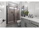 Modern bathroom featuring gray tile shower, dark fixtures, and vanity with white countertop at 30 Spanish Oak Dr, Youngsville, NC 27596