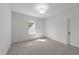 Bright bedroom features neutral carpet, white walls, and a bright window at 30 Spanish Oak Dr, Youngsville, NC 27596