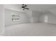 Spacious bonus room features neutral carpet, a ceiling fan, and a bright window providing lots of natural light at 30 Spanish Oak Dr, Youngsville, NC 27596