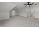 This bonus room features neutral carpet, a ceiling fan, bright white paint and easy access to other rooms at 30 Spanish Oak Dr, Youngsville, NC 27596
