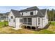 Back exterior view of a home with a screened-in porch and a well-maintained lawn at 30 Spanish Oak Dr, Youngsville, NC 27596