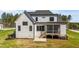 Back exterior view of a home with a screened-in porch and a well-maintained lawn at 30 Spanish Oak Dr, Youngsville, NC 27596