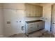 Spacious laundry room featuring ample cabinet storage and counter space at 30 Spanish Oak Dr, Youngsville, NC 27596