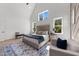 Spacious bedroom featuring large windows, a cozy sitting area, and plush bedding at 30 Spanish Oak Dr, Youngsville, NC 27596