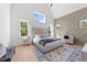 Bright main bedroom with vaulted ceiling, large windows, and stylish decor at 30 Spanish Oak Dr, Youngsville, NC 27596