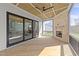 Covered porch featuring a stone fireplace, wood flooring, and sliding doors at 30 Spanish Oak Dr, Youngsville, NC 27596
