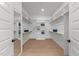 Bright, empty walk-in closet with wood floors, custom shelving, and ample storage space at 30 Spanish Oak Dr, Youngsville, NC 27596