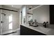 Modern bathroom features dual sinks, sleek black fixtures, and a walk-in shower with glass door at 512 Gordon St # 1102, Durham, NC 27701