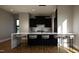 Modern kitchen with a large island, bar stool seating, and sleek black cabinetry with marble backsplash at 512 Gordon St # 1102, Durham, NC 27701