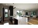 Open-concept kitchen features a large island, modern black appliances, and sleek lighting at 512 Gordon St # 1102, Durham, NC 27701