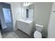 Bright bathroom features a modern vanity with white countertop and a large, well-lit mirror at 85 Claude Creek Way, Smithfield, NC 27577