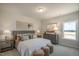 Cozy bedroom with neutral décor, a plush bed, and soft lighting for a relaxing retreat at 85 Claude Creek Way, Smithfield, NC 27577