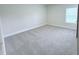 A bright bedroom features neutral carpet, white trim, and a window at 85 Claude Creek Way, Smithfield, NC 27577