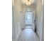 Bright entryway featuring wainscoting and a modern door with glass panels, allowing for plenty of natural light at 85 Claude Creek Way, Smithfield, NC 27577