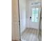 Inviting entryway featuring wainscoting, wood-look flooring, and a bright white front door with glass panels at 85 Claude Creek Way, Smithfield, NC 27577