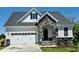 Charming home with a stone-accented entrance, white siding, and a two-car garage at 85 Claude Creek Way, Smithfield, NC 27577