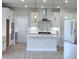 This kitchen boasts white cabinets, stainless steel appliances, and a center island with a sink at 85 Claude Creek Way, Smithfield, NC 27577