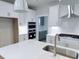 This modern kitchen features white cabinetry, stainless steel appliances, and a large island with a sink at 85 Claude Creek Way, Smithfield, NC 27577