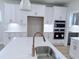 This gourmet kitchen features white cabinetry, stainless steel appliances, and a large island with a sink at 85 Claude Creek Way, Smithfield, NC 27577