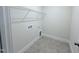 Functional laundry room featuring tile flooring, white walls, and convenient hookups for washer and dryer at 85 Claude Creek Way, Smithfield, NC 27577