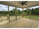 Screened-in porch offers wooded views, a ceiling fan, and plenty of space to relax outdoors at 85 Claude Creek Way, Smithfield, NC 27577