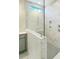 Modern walk-in shower featuring marble tiling, sleek fixtures, and frameless glass enclosure at 85 Claude Creek Way, Smithfield, NC 27577